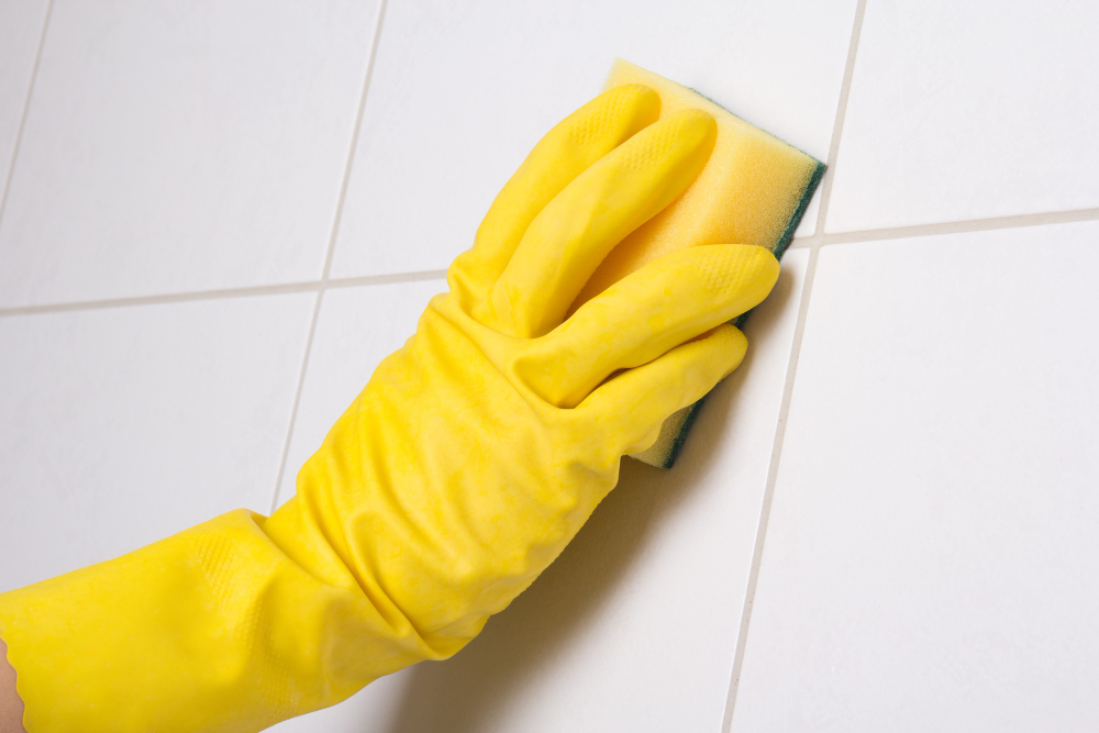 Hand Yellow Glove Cleaning Tile Wall