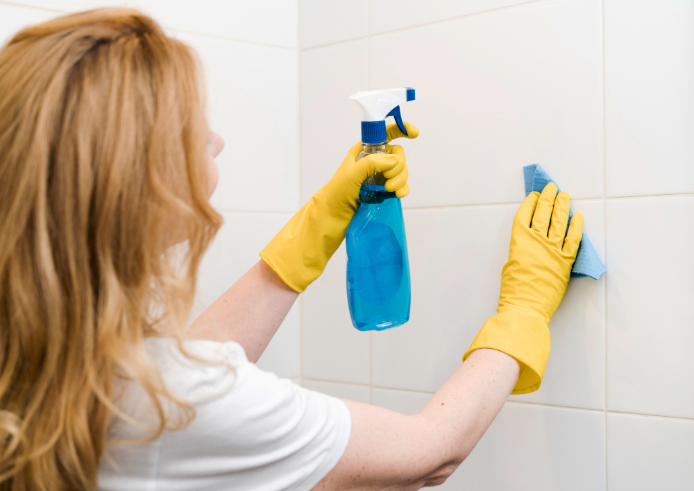 side-view-woman-cleaning-shower-wall