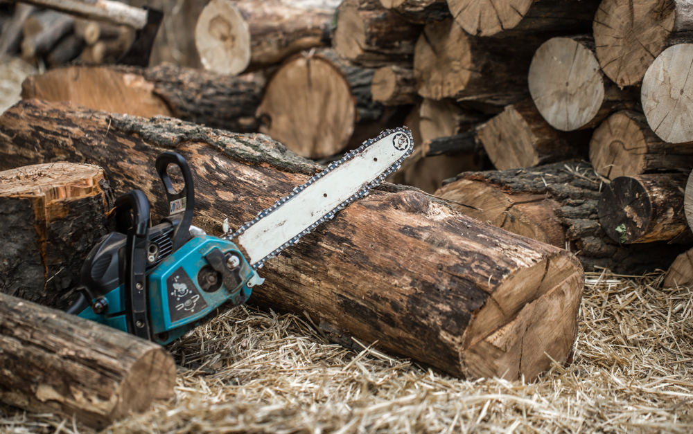 Man Chopping Wood With Chainsaw