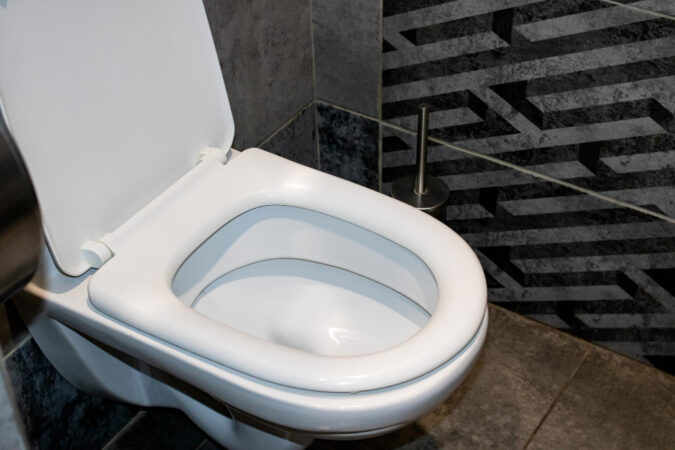 white-toilet-gray-tiles-close-up