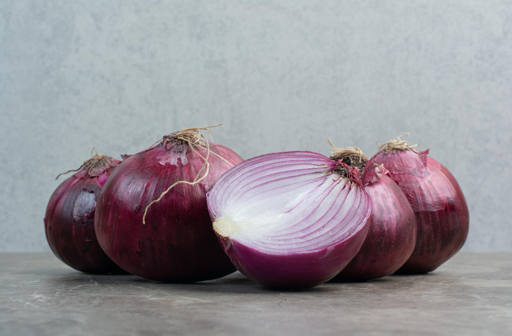 red-onion-bulbs-marble-background-high-quality-photo