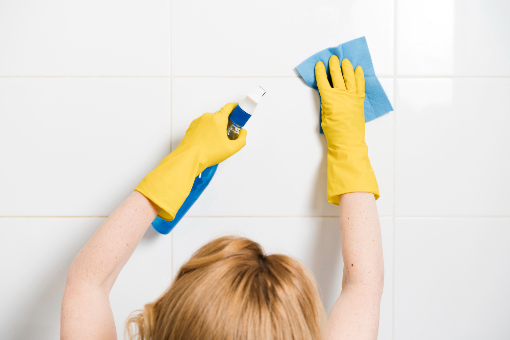 woman-cleaning-shower-wall