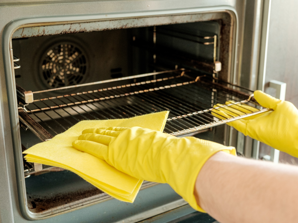 male-hand-with-gloves-cleaning-oven