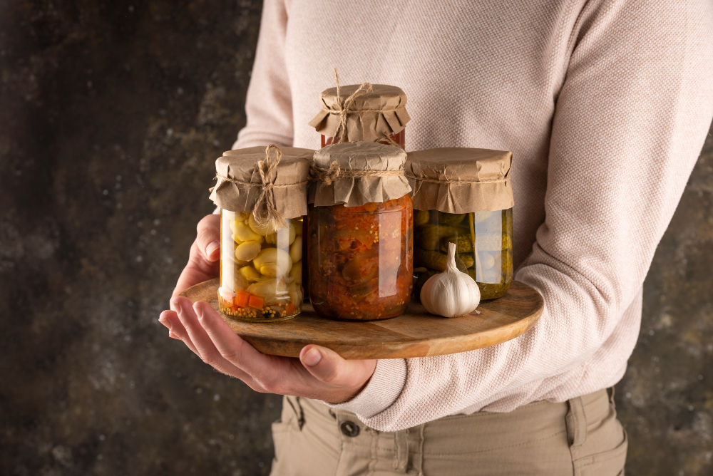 close-up-hand-holding-board-with-jars