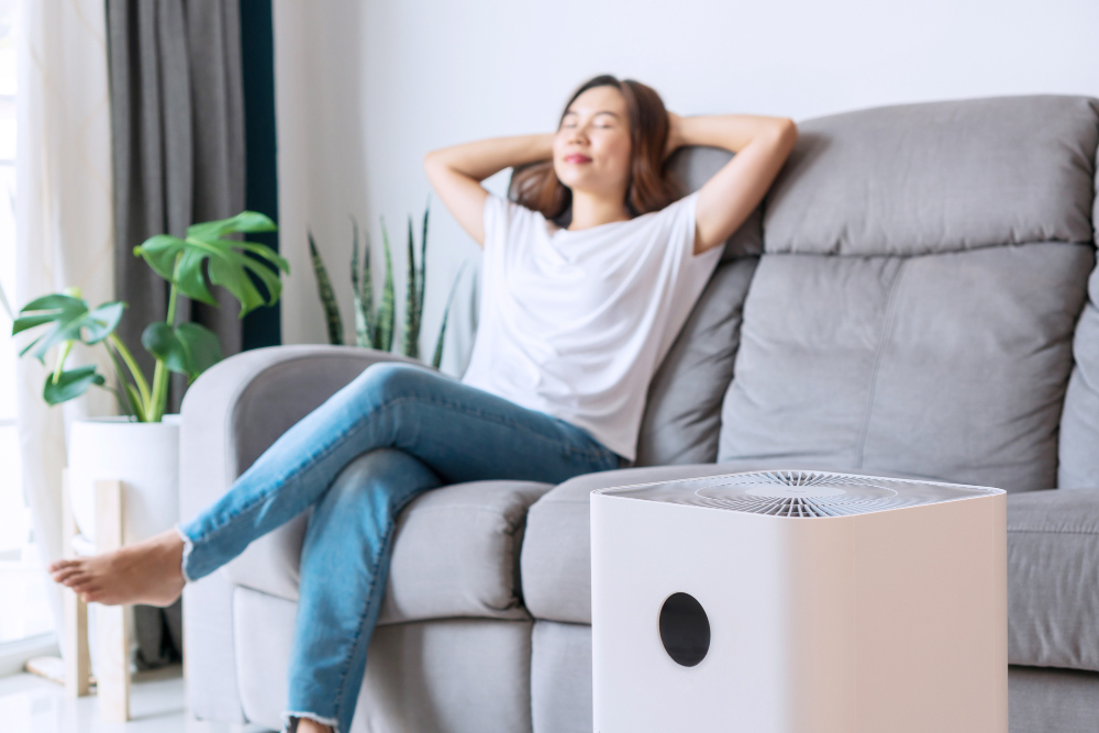 asian-woman-relaxing-comfortable-sofa-home-with-purifier-beside