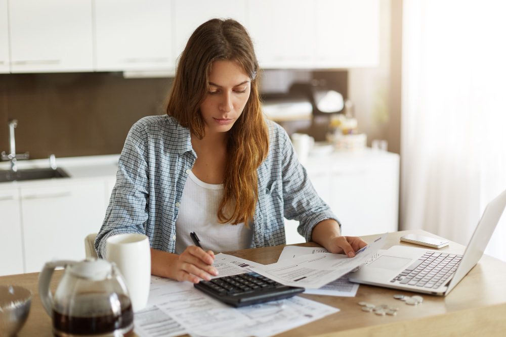 Young Woman Checking Her Budget Doing Taxes