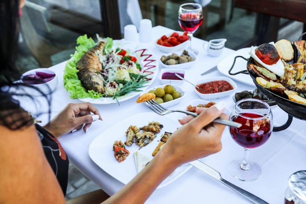 Woman Eating Various Food While Sitting Restaurant