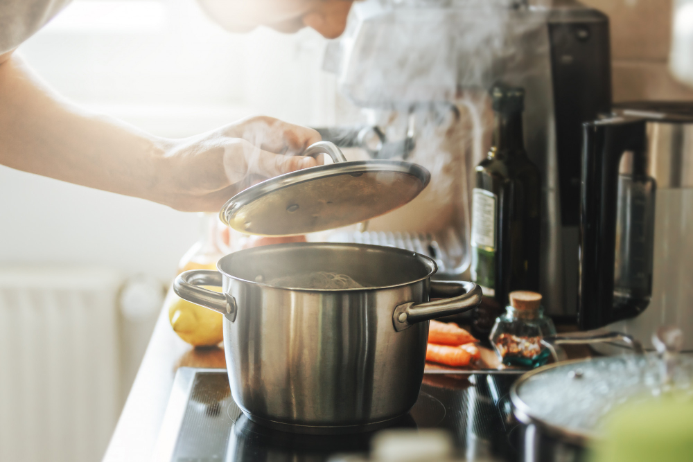 Young Man Cooking Fresh Food Home Opening Lid Steaming Pot