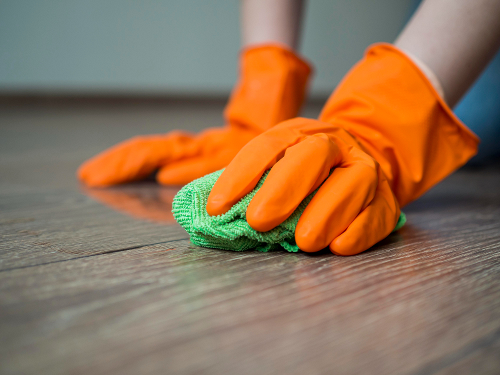 Close Up Hands With Rubber Gloves Cleaning Floor