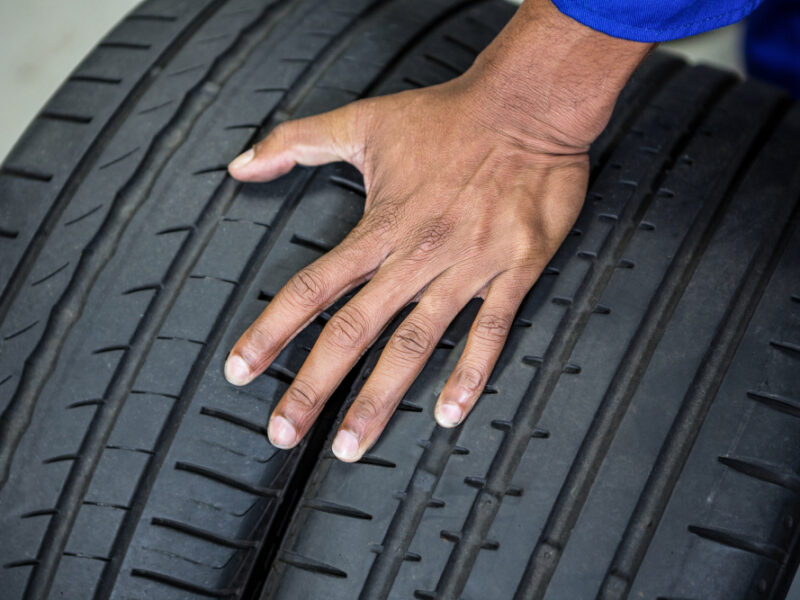 Hand Mechanic Holding Tyres