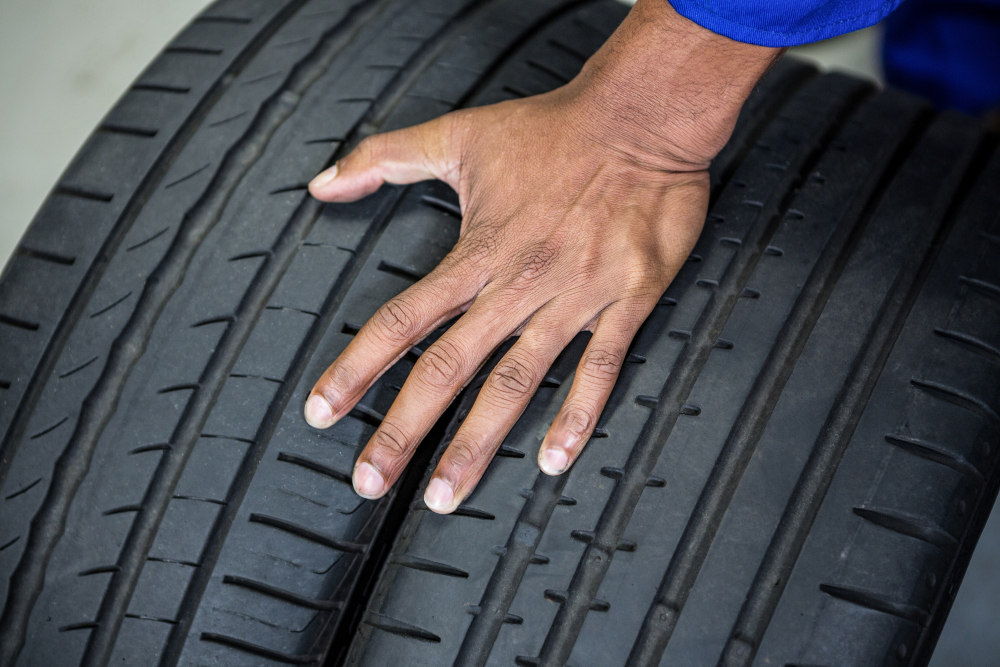 Hand Mechanic Holding Tyres