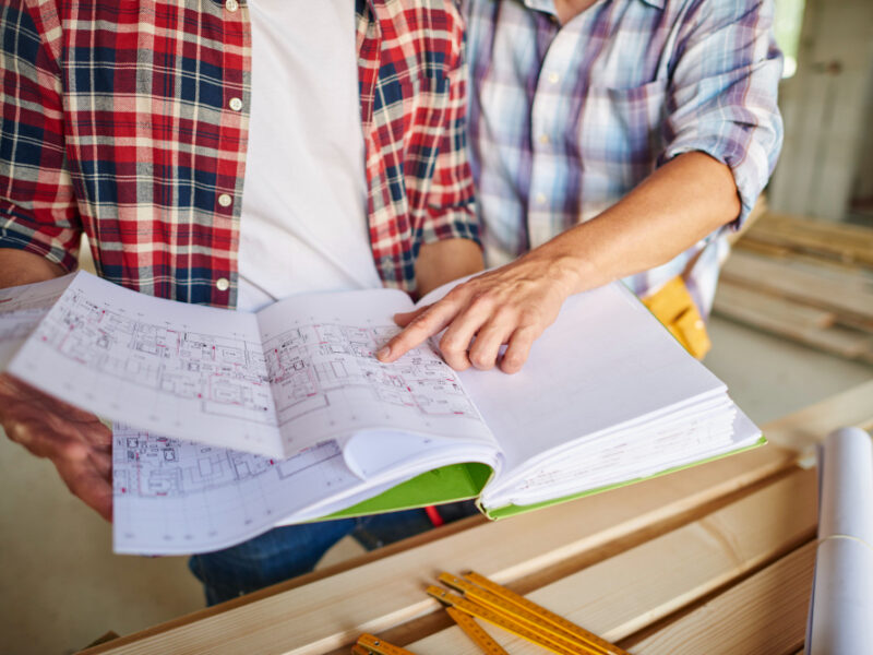 Handsome Young Carpenter Working With Experienced Man