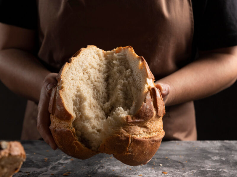 Chef Tearing Freshly Baked Bread Apart