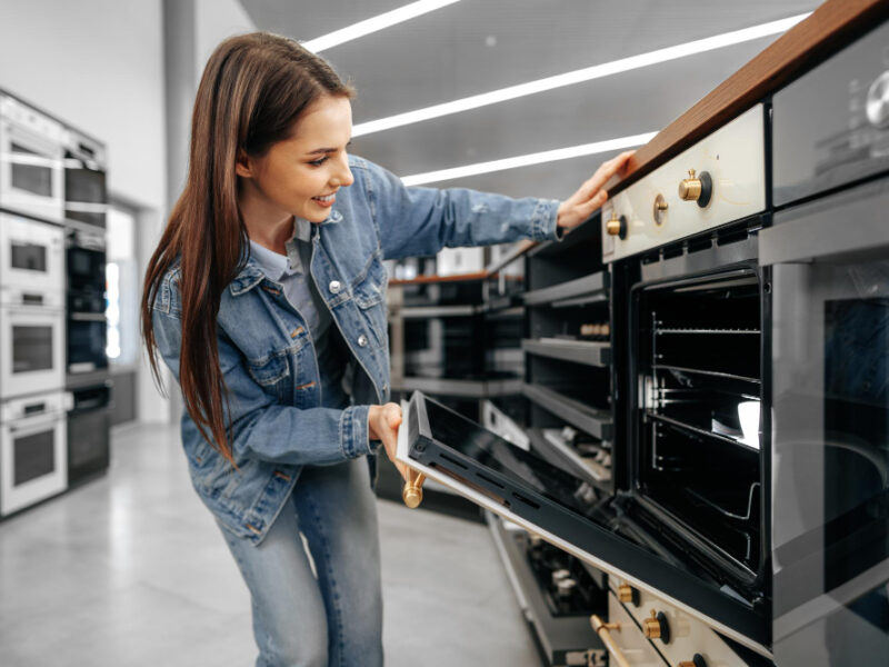 Young Woman Looking New Electric Oven Shopping Mall