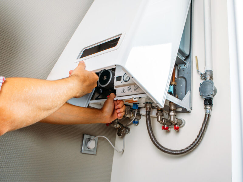 Plumber Attaches Trying Fix Problem With Residential Heating Equipment Repair Gas Boiler