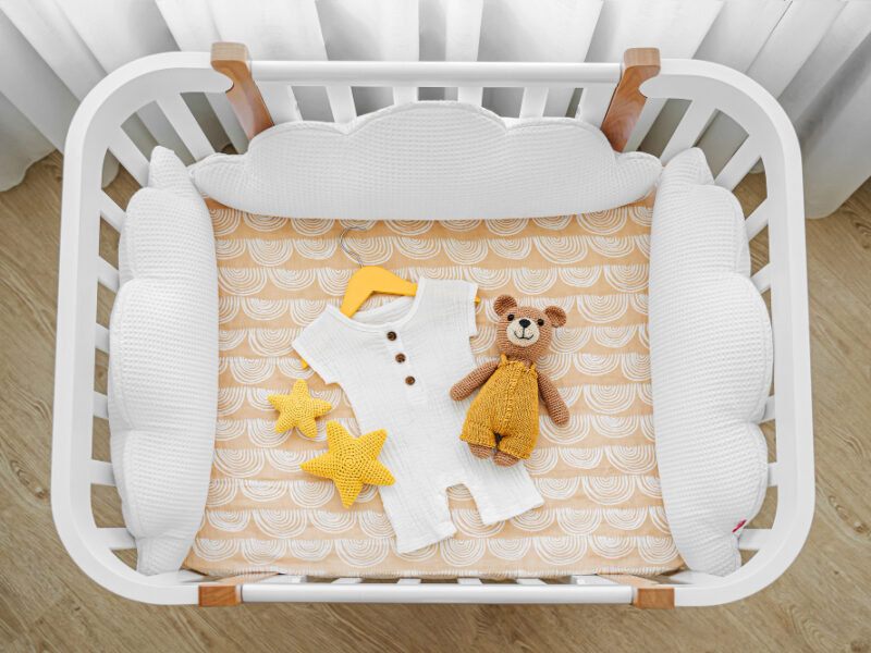 Baby Romper With Toy Bear Newborn Cot Cradle White Wooden Baby Crib With Pillows Shaped Clouds Baby S Room Top View Child S Bed