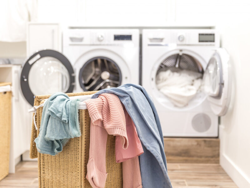 laundry-basket-with-dirty-clothes-with-washing-drying-machines-background