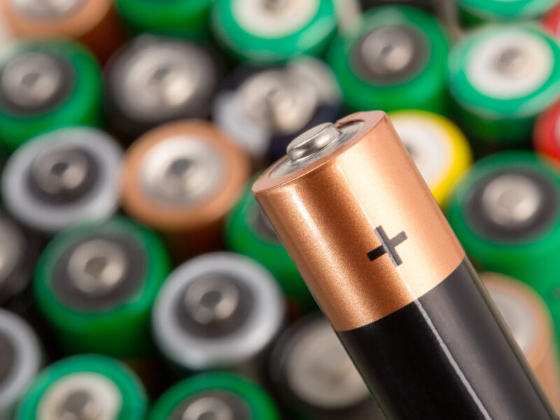 Closeup Battery Against Many Other Batteries