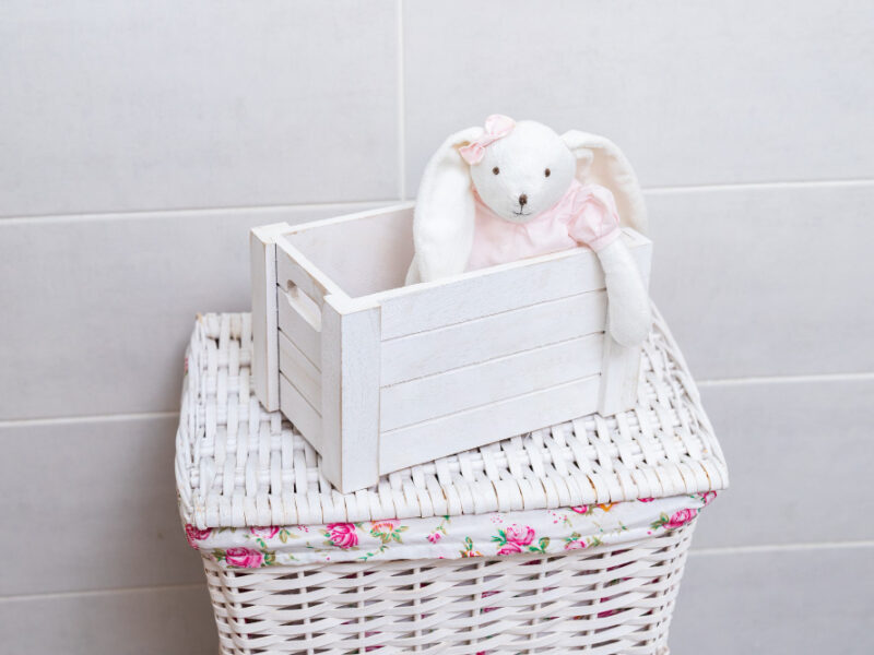white-toy-rabbit-pink-dress-sits-white-wooden-box-wicker-laundry-basket